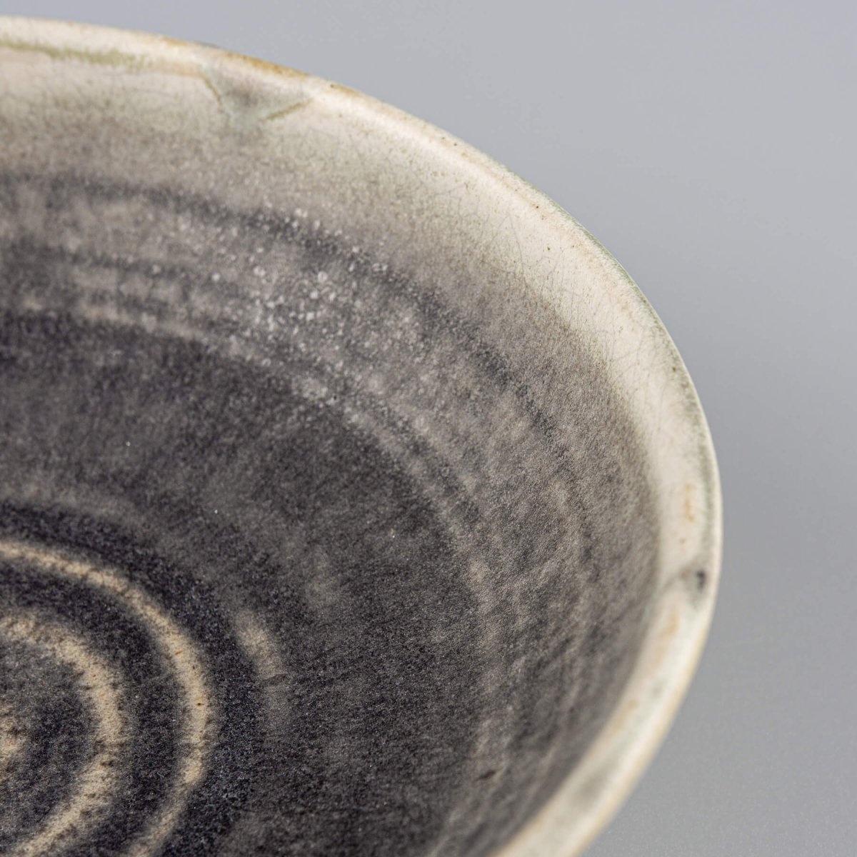 Hand-thrown ceramic bowl with carved details and green finish, excellent for kitchenware and home settings.