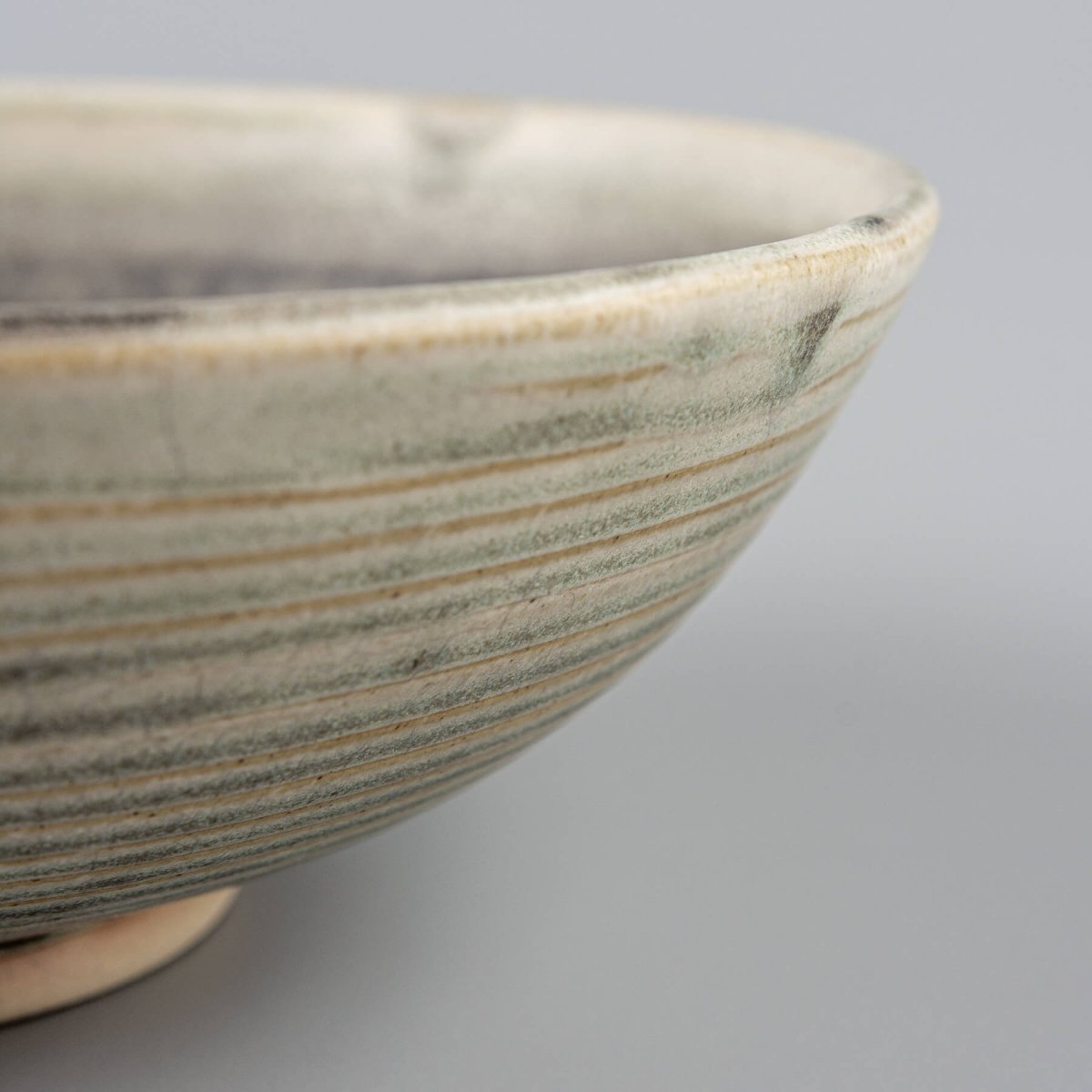 Decorative ceramic bowl with artisan craftsmanship and minimal glaze for rustic and modern table arrangements.