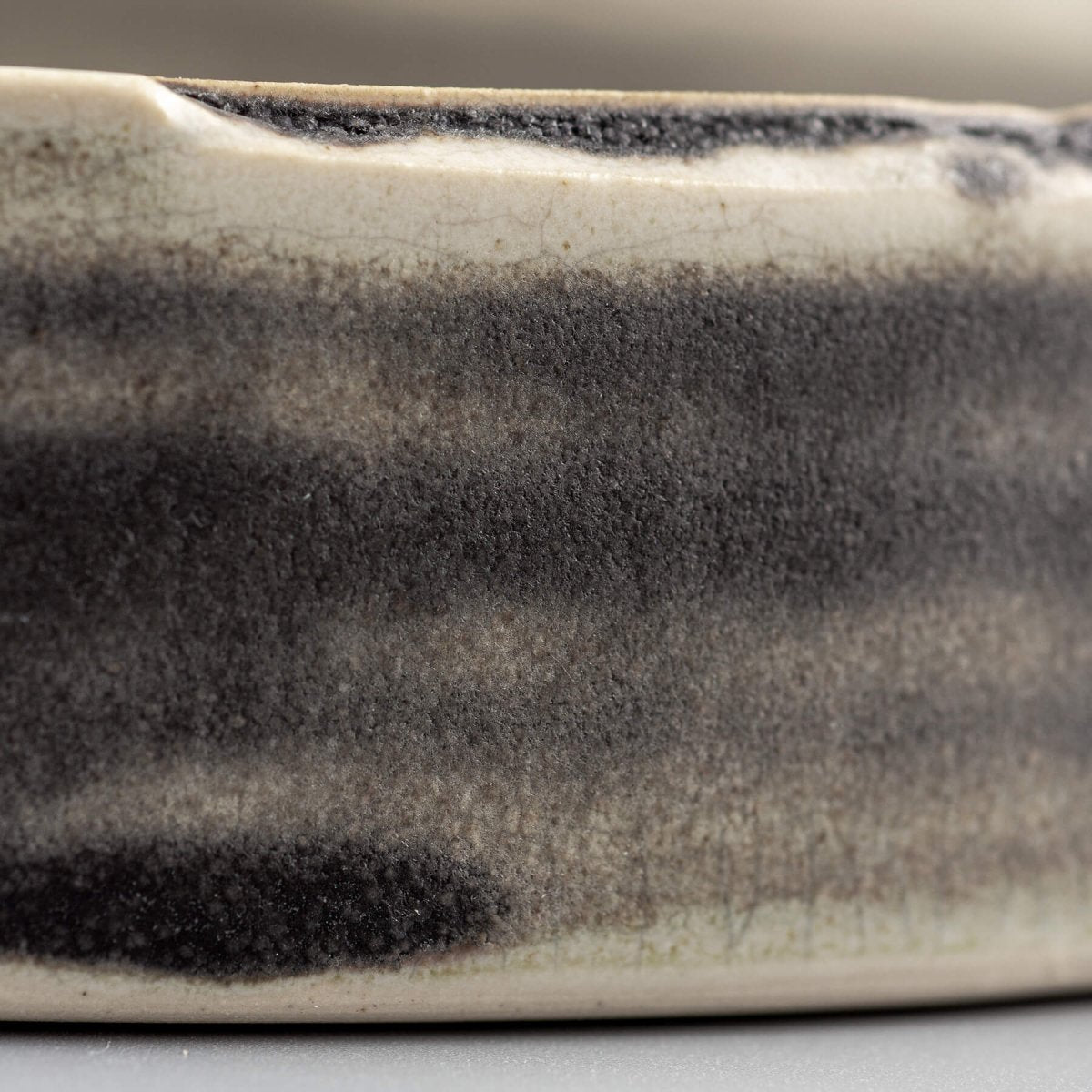Detail shot of stoneware dinner plate showing subtle glaze variations and handcrafted beauty.