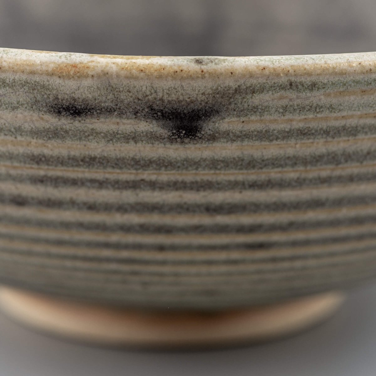 Stoneware bowl with glazed interior and raw textured exterior, suitable for serving or as a centerpiece decor item.