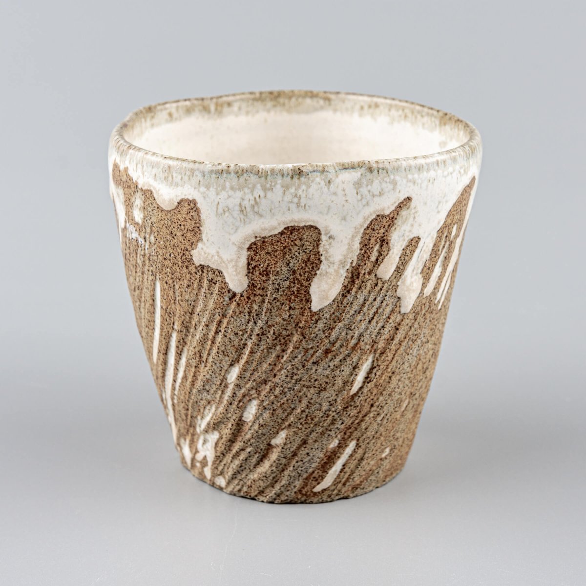 Ceramic espresso mugs with carved texture and earthy brown stoneware finish.