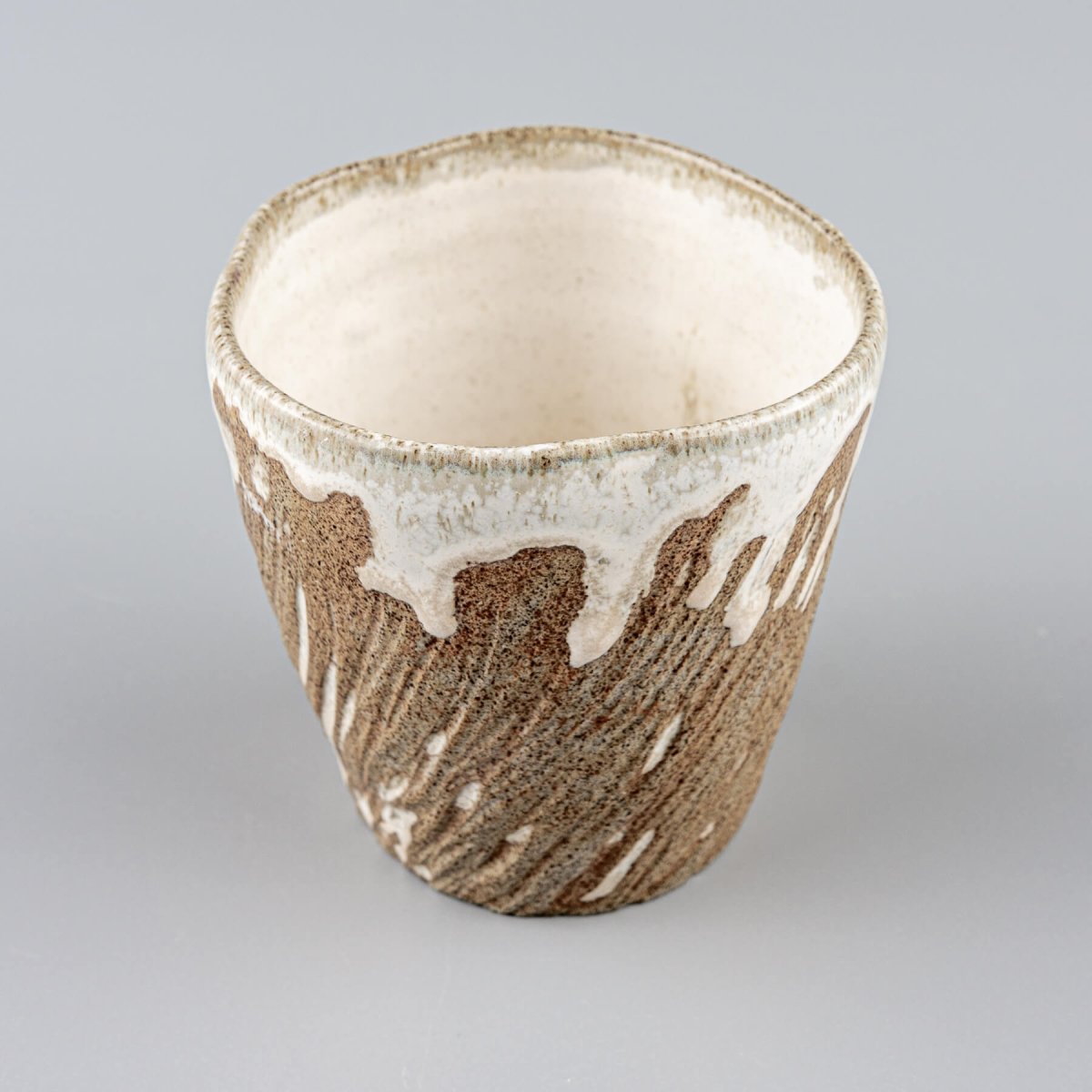 Handmade ceramic espresso mug with earthy stoneware body and semi-gloss white glaze accent.