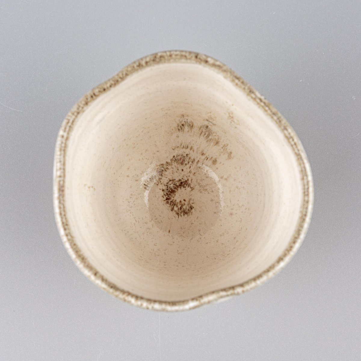 Top view of ceramic espresso mug with glazed interior and smooth rim.