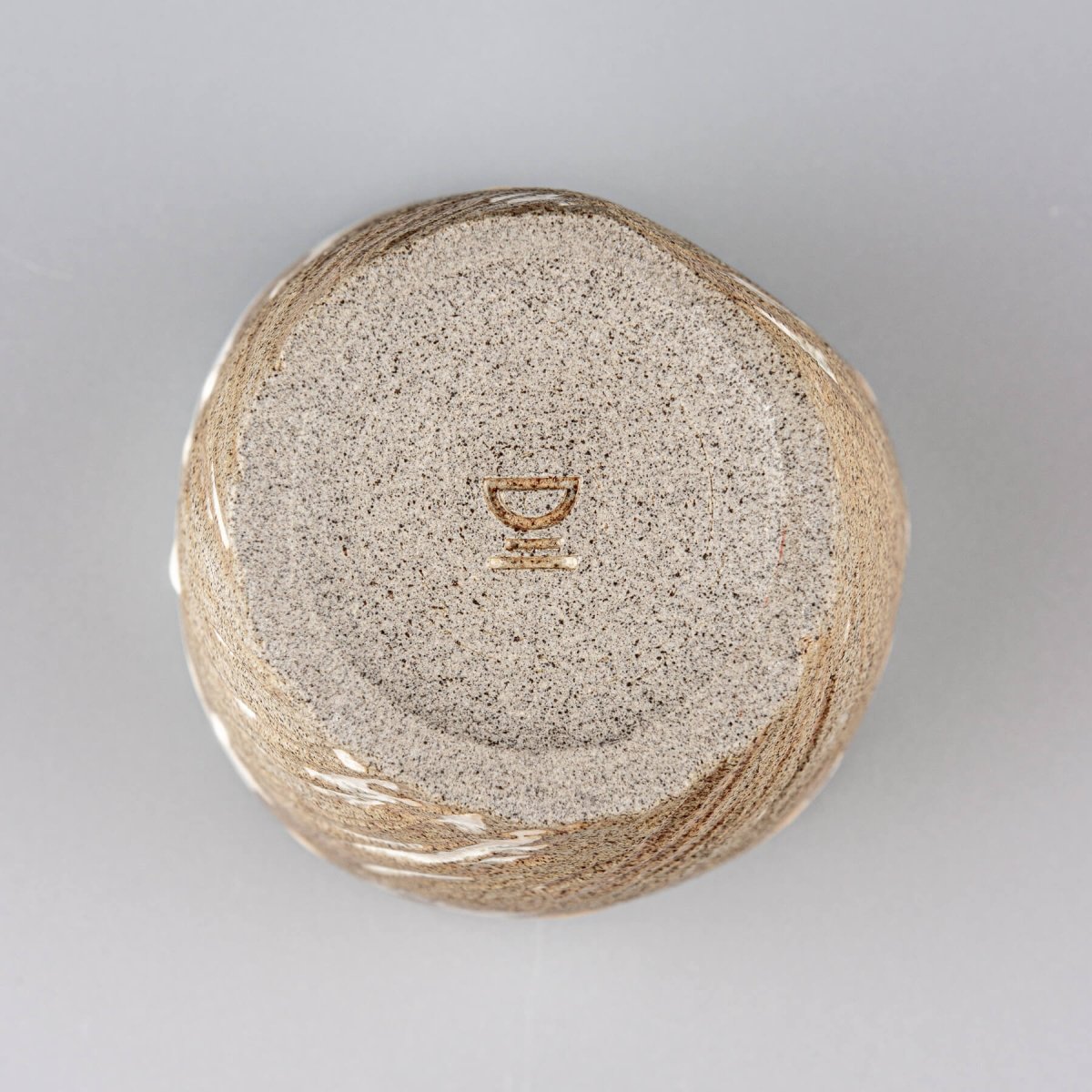 Bottom view of ceramic espresso mug showing handcrafted base detail.