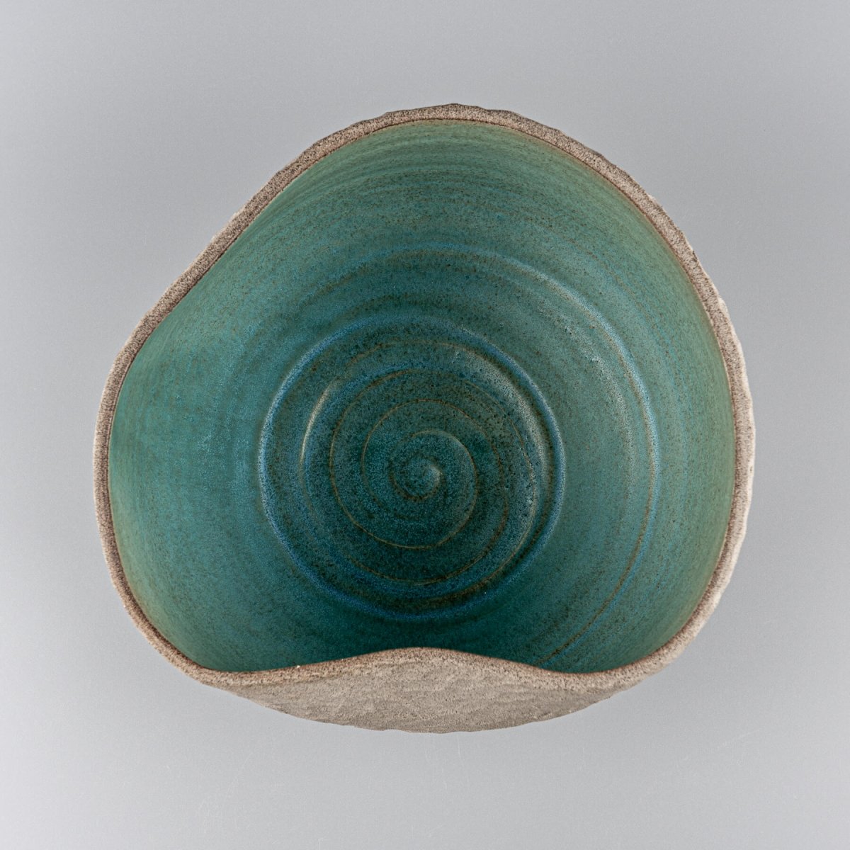 Decorative ceramic vases centerpiece with carved stoneware texture and handmade turquoise glaze.