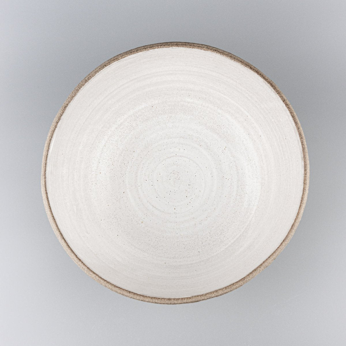 Top view of artisan ceramic bowl showcasing wide bevel and smooth glazed surface ideal for culinary presentation.