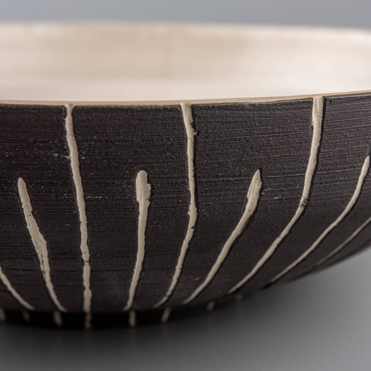 Perspective view highlighting elegant hand-carved texture and bowl curvature.