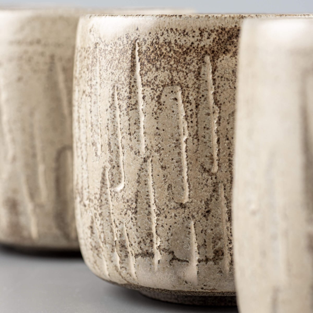 Detailed rim texture of ceramic handmade cup with rustic carved surface.