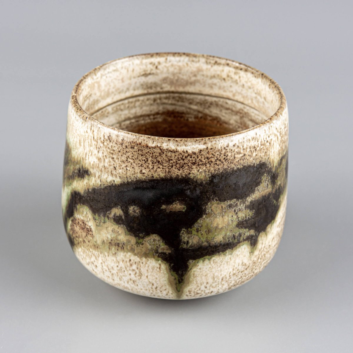Luxury artisanal stoneware mugs with earthy tones and organic glaze design.