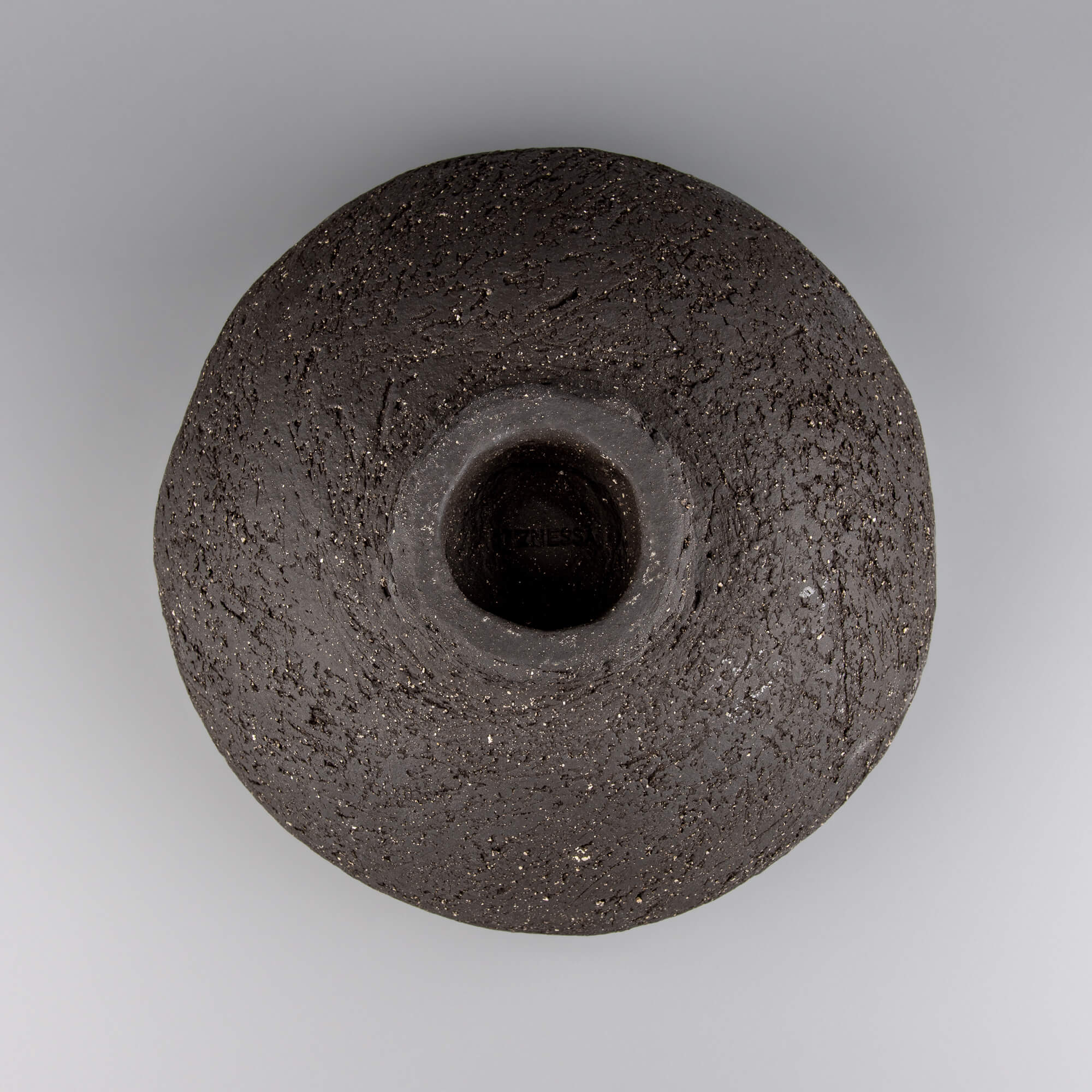 Handcrafted centerpiece underside with raised foot and raw texture for collectible pottery displays.