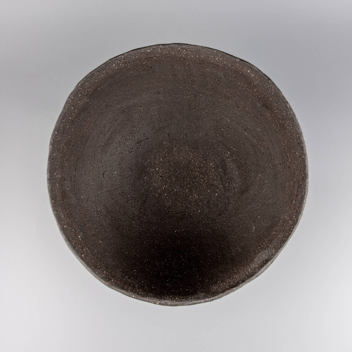 Handcrafted centerpiece top view showing dark ceramic interior for luxury tableware and home styling.