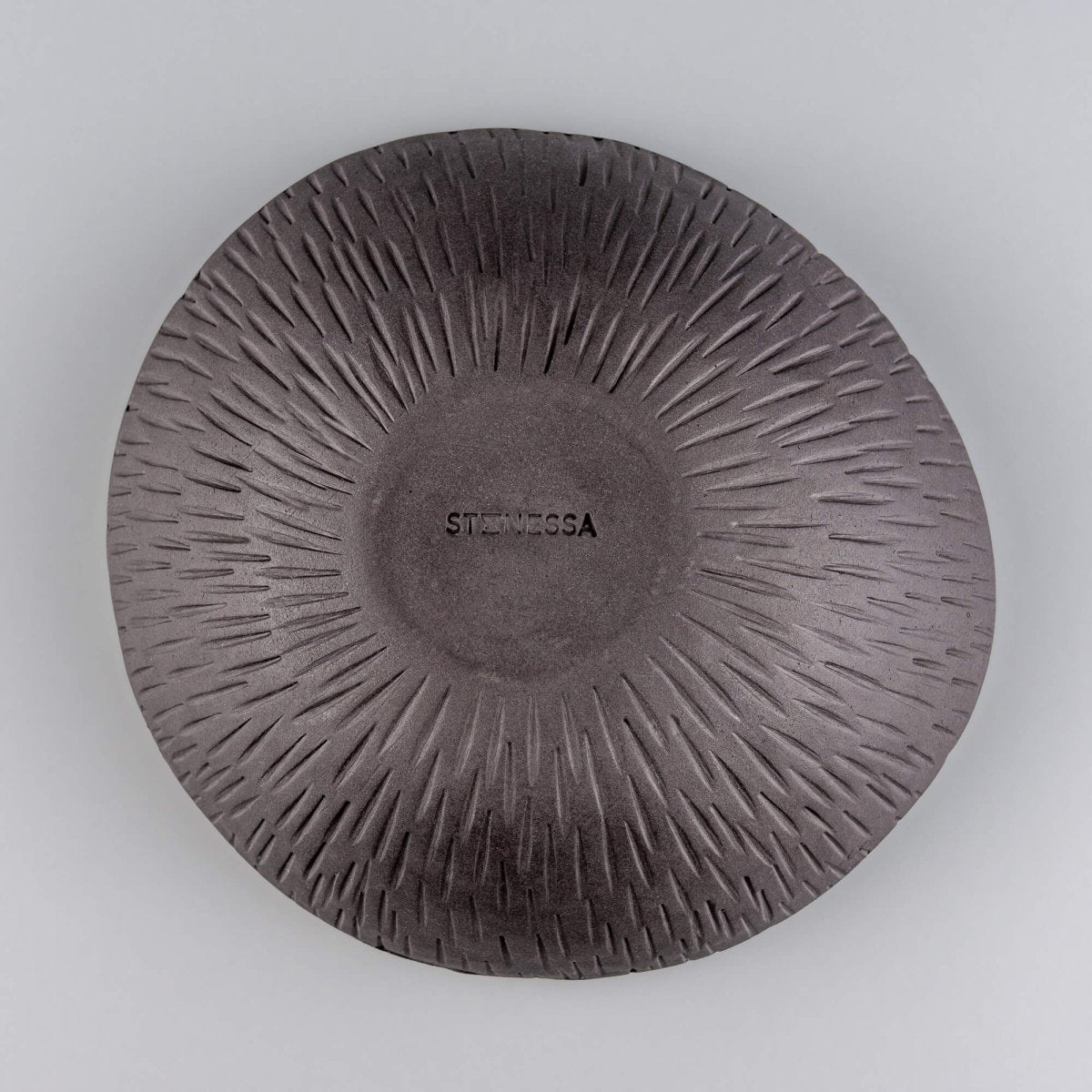 Bottom view of a handmade ceramic bowl with a carved exterior, suitable for luxury tableware and boutique hotel use.
