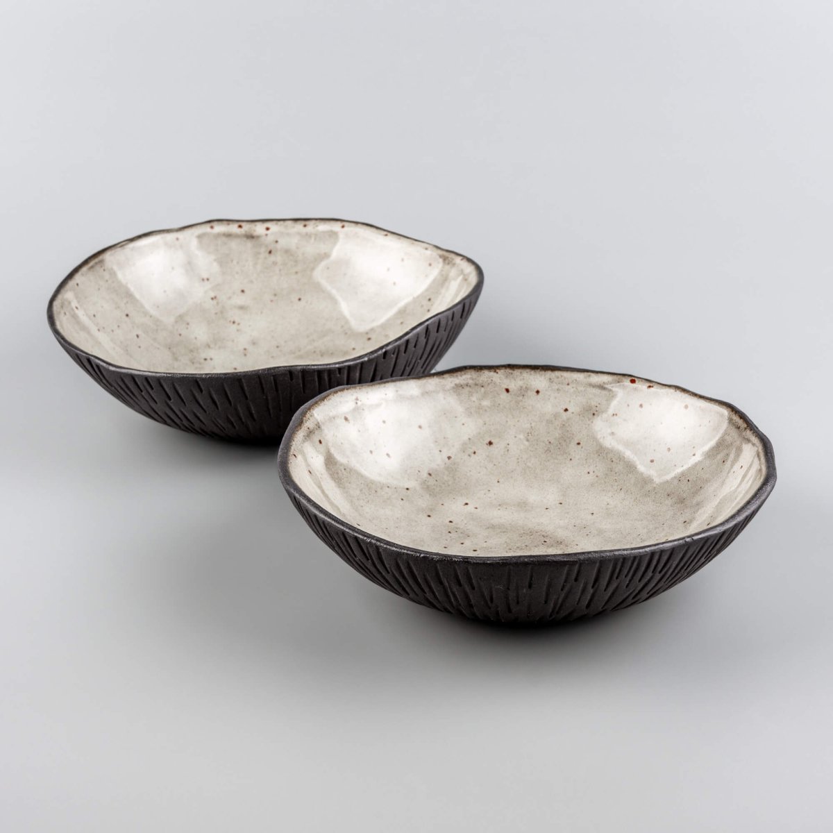 Set of handmade ceramic bowls arranged for fine dining service in upscale restaurant and culinary environments.