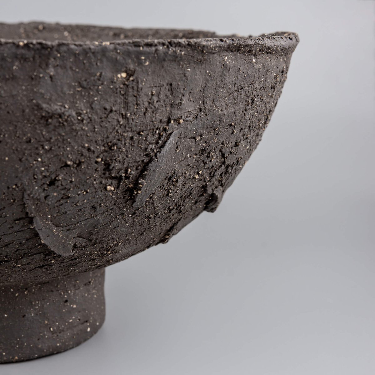 Handmade decorative bowl with dramatic textured exterior, footed base, and fine dining or restaurant centerpiece style.